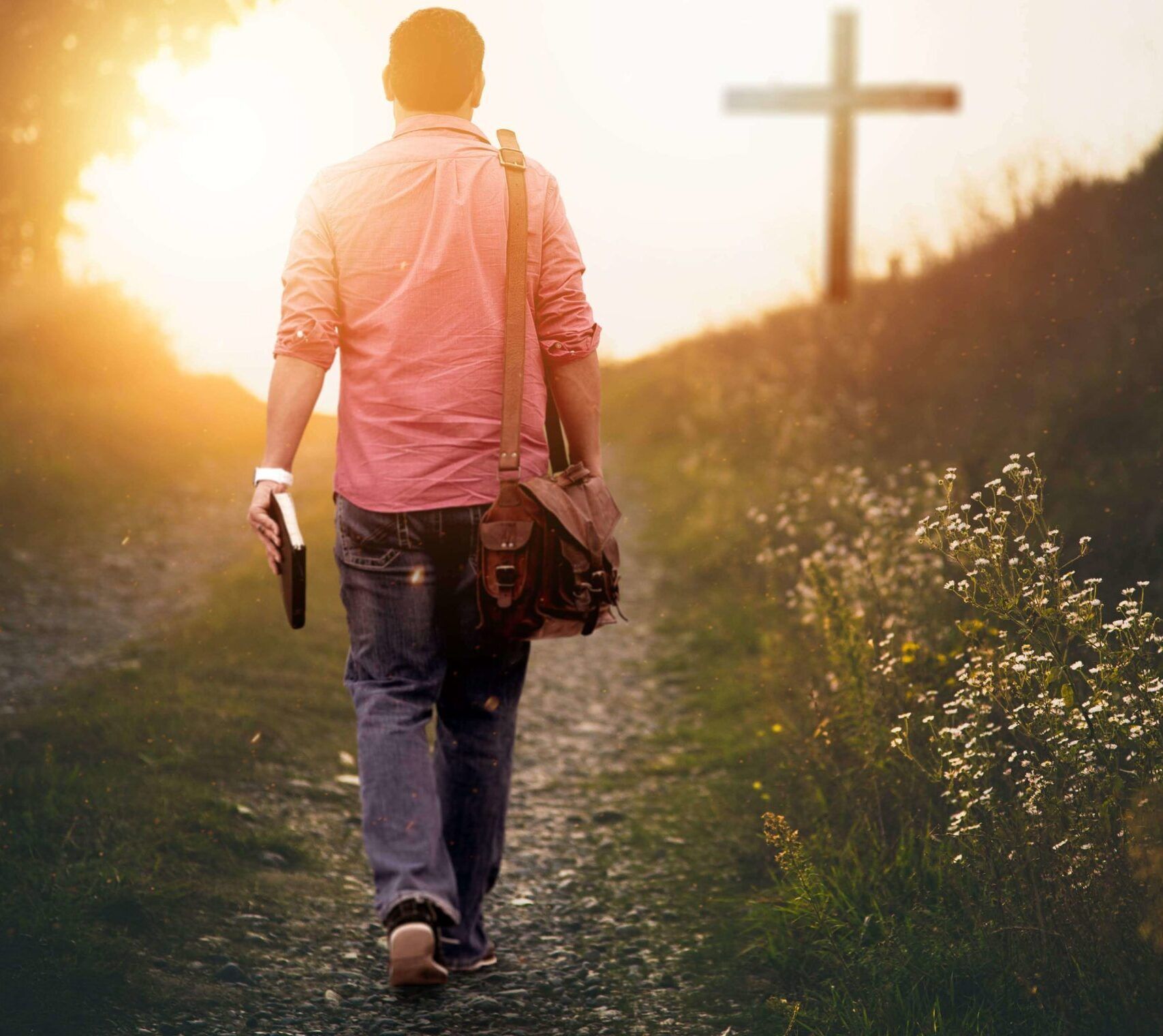 Man walkning towards a cross